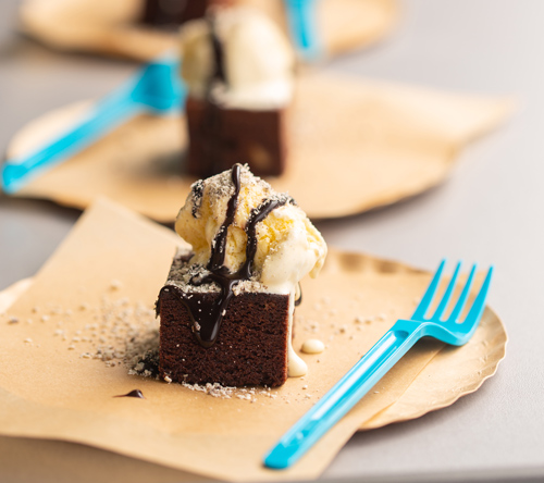 decadent chocolate brownie topped with ice cream and chocolate sauce served on a plate with a blue fork perfect for dessert lovers 3 ways to enjoy